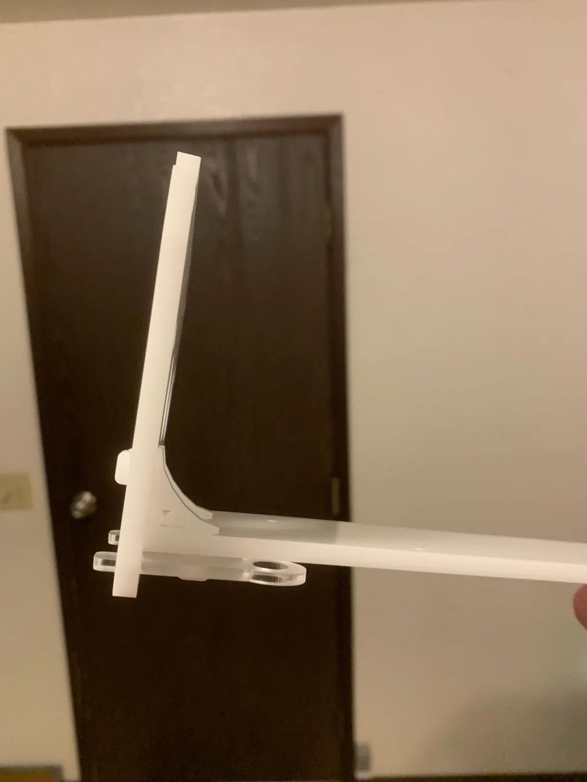 The Rev 1 swing-bracket arm in white, the desk-mount mechanism that would let the case tilt up off the bench.
